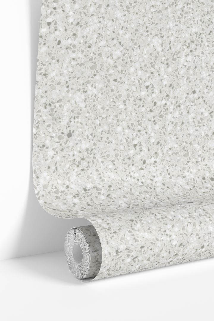 Ivory Terrazzo Collective wallpaper roll showing light neutral stone speckled pattern