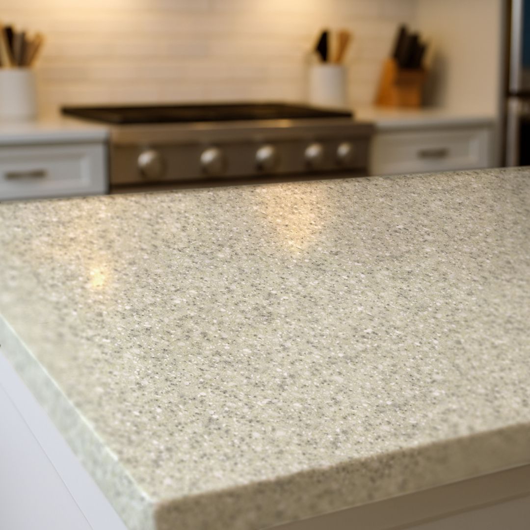 soft shoreline countertop film with light gray speckled stone design on a modern kitchen island