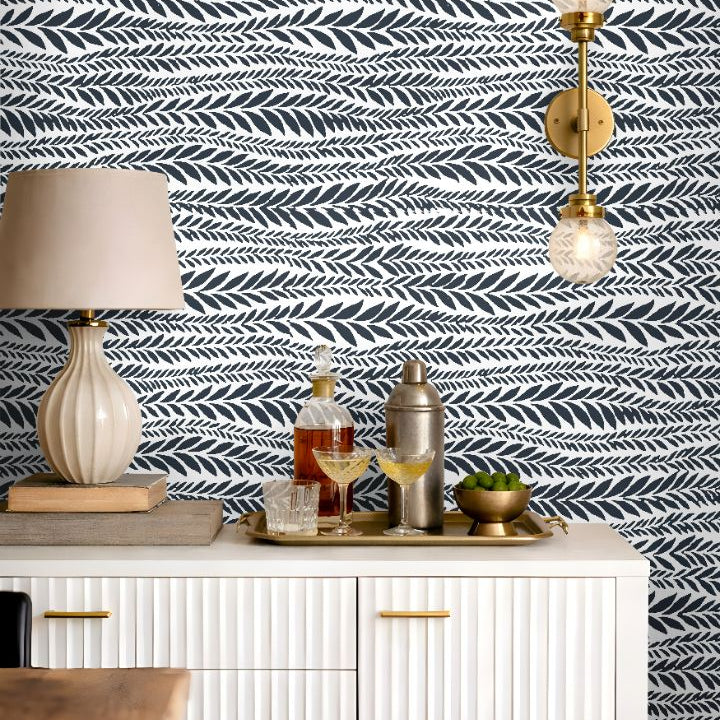 laurel row blue botanical wallpaper styled behind bar cabinet with brass accents