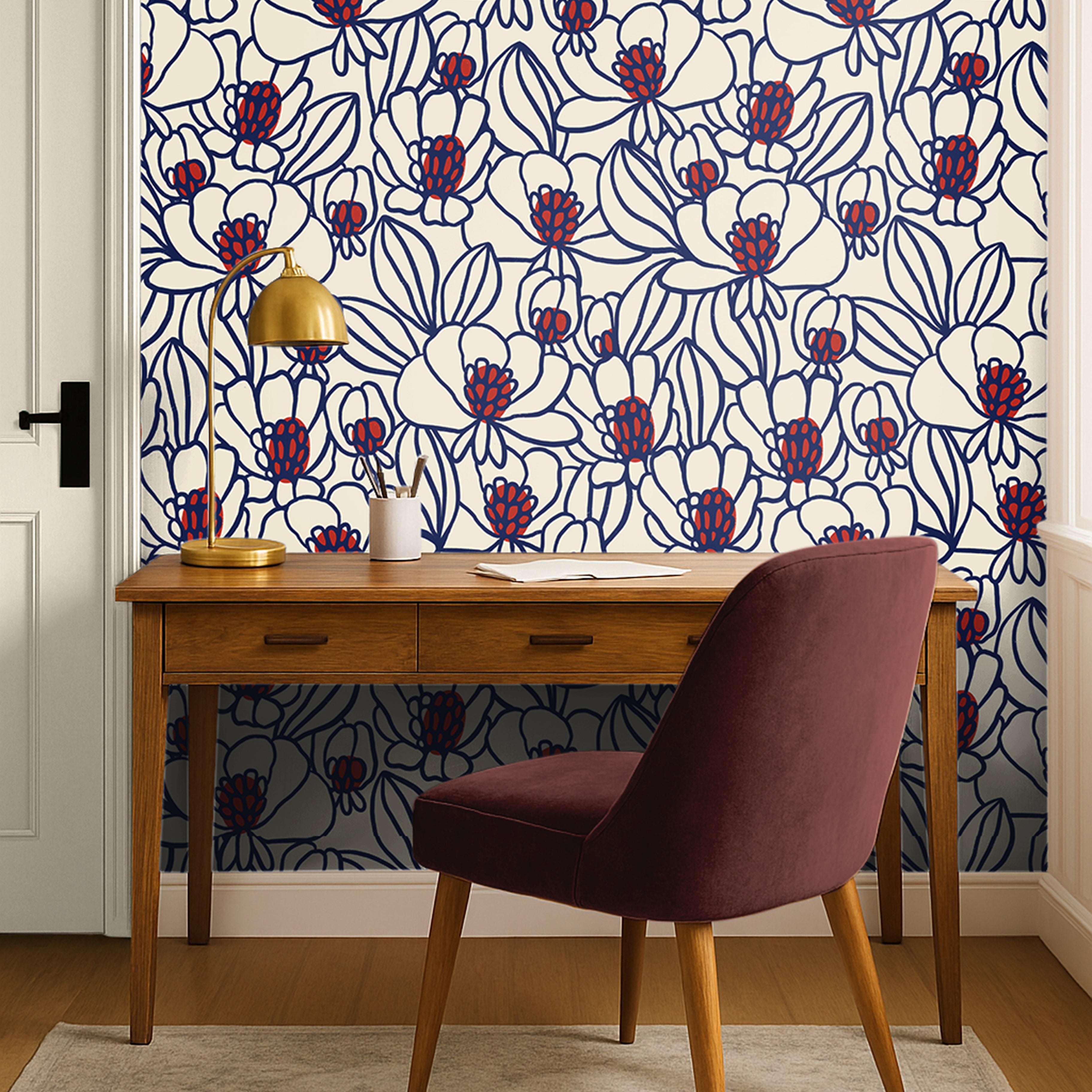 Bold floral wallpaper with cobalt blue outlines and red botanical accents styled in a modern office with walnut furniture.