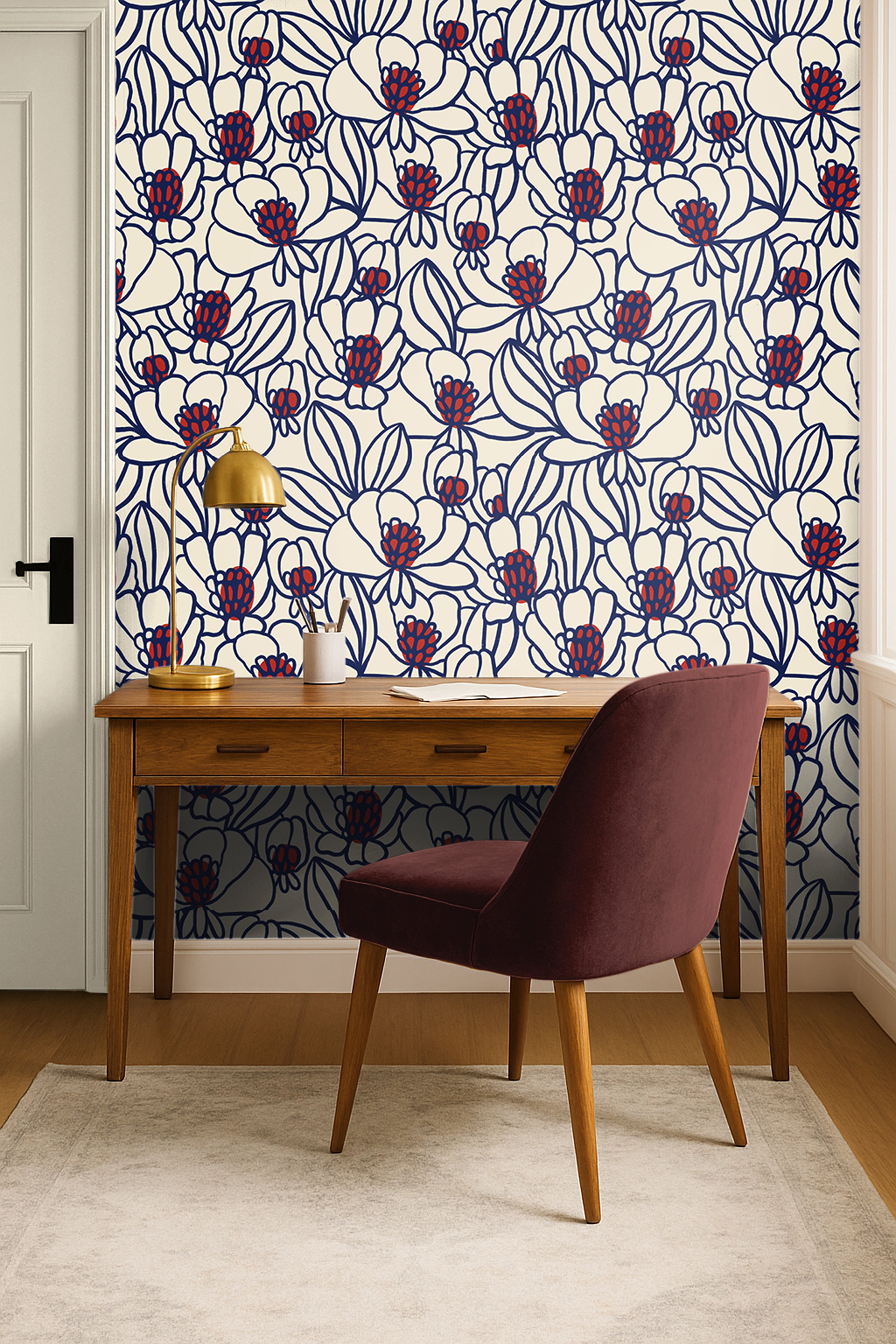 Bold floral wallpaper with cobalt blue outlines and red botanical accents styled in a modern office with walnut furniture.