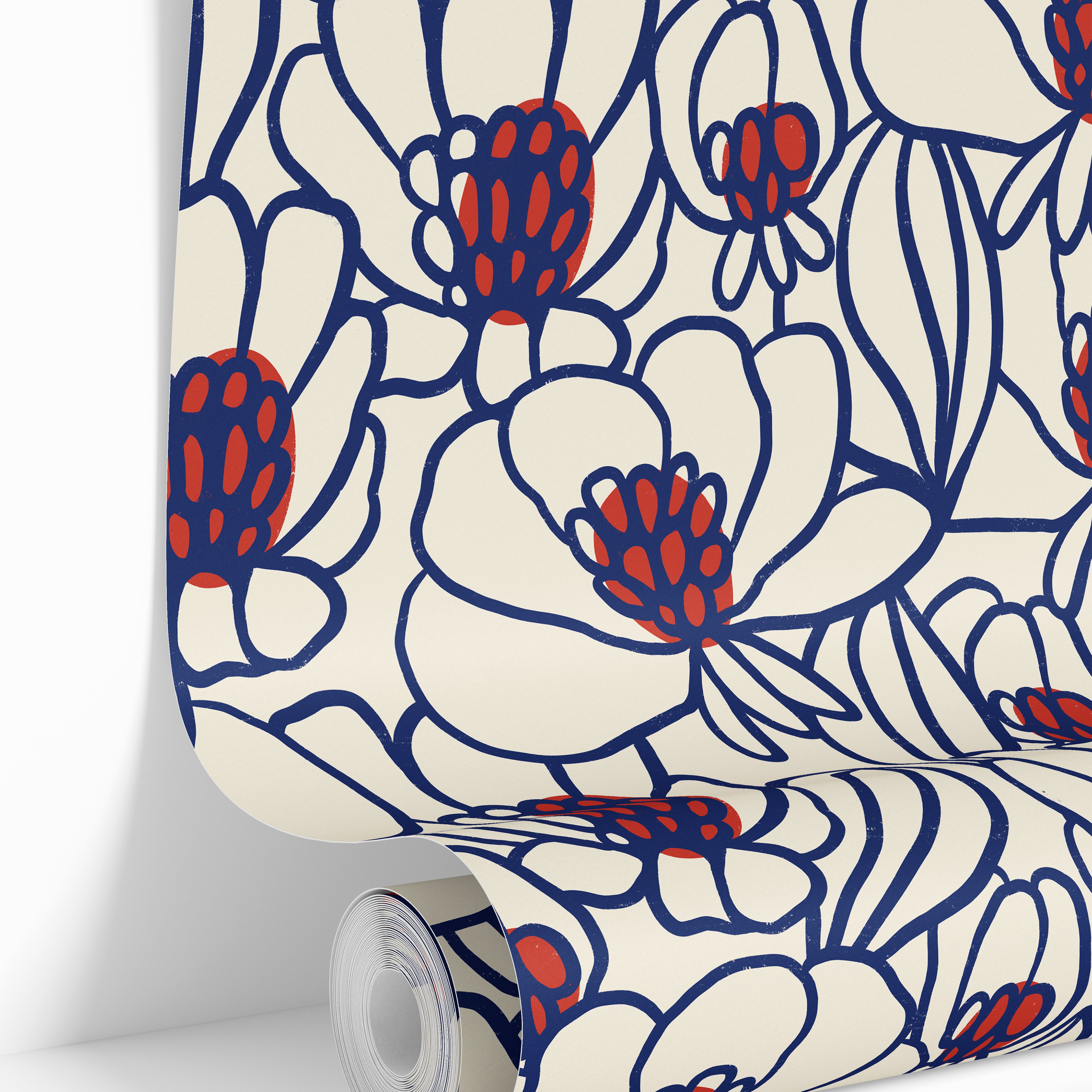 Wallpaper roll featuring Magnolia Rogue floral wallpaper with oversized ivory blooms, cobalt outlines, and red botanical details.