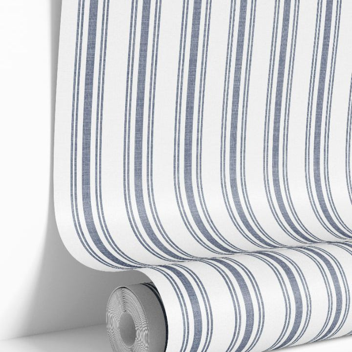 Close-up of Mariner’s Thread Wallpaper 2267 roll showing deep blue stripes and woven texture on a white background.