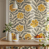 Mid-century inspired floral wallpaper with warm golden flowers creating a soft nostalgic interior atmosphere.