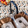 Kitchen sink area finished with Marlo Terra Stone Countertop Film, showing a refined terrazzo pattern for a warm, contemporary look