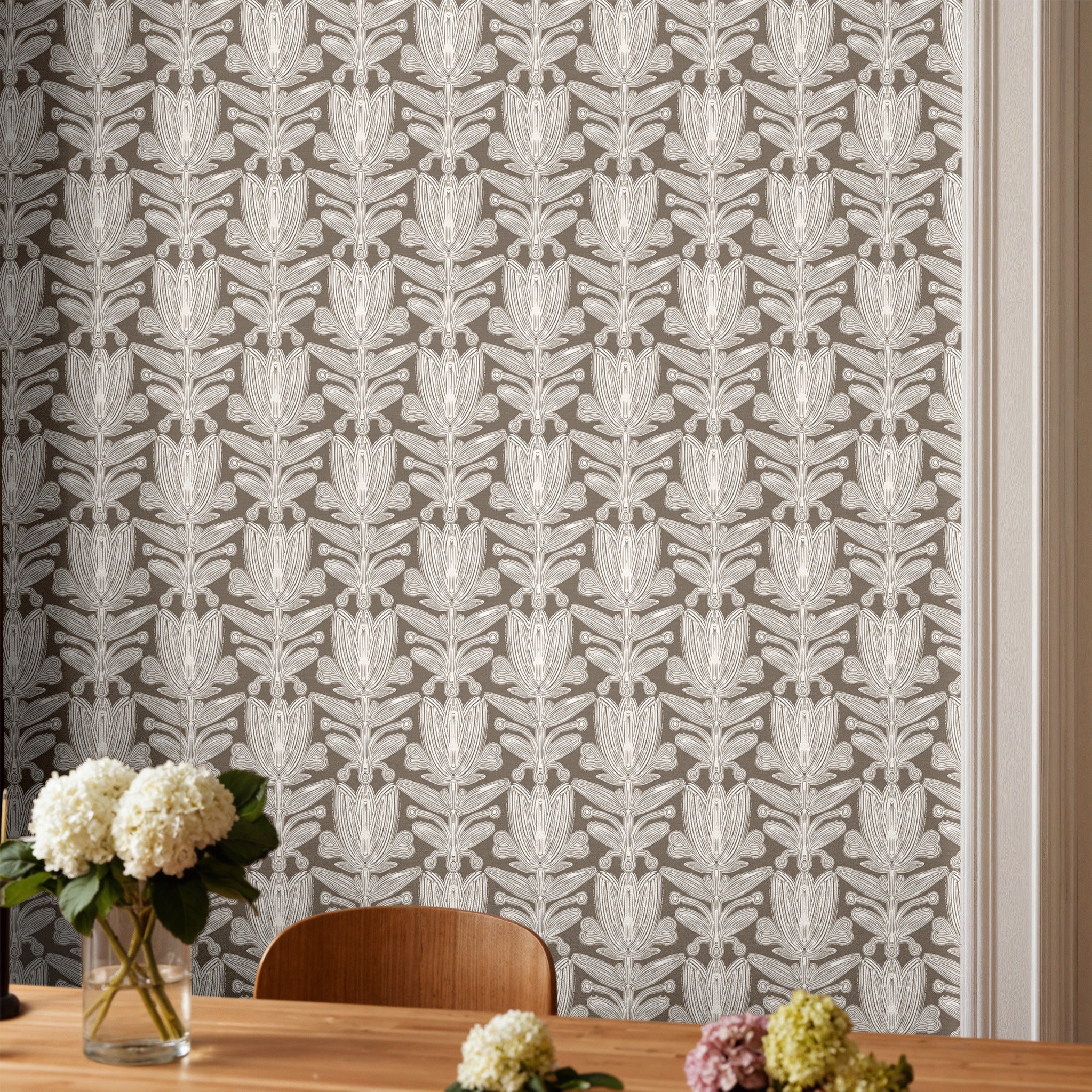 Neutral taupe botanical wallpaper with white floral pattern styled in a modern dining room setting with natural wood furniture