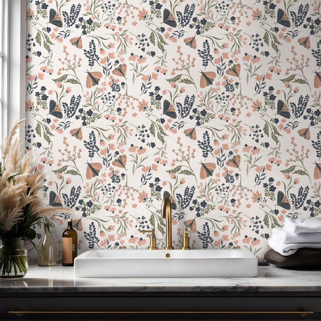 Bathroom wall featuring Mossmere Wilds wallpaper with wildflowers, butterflies, and sage botanical stems on a soft neutral background.