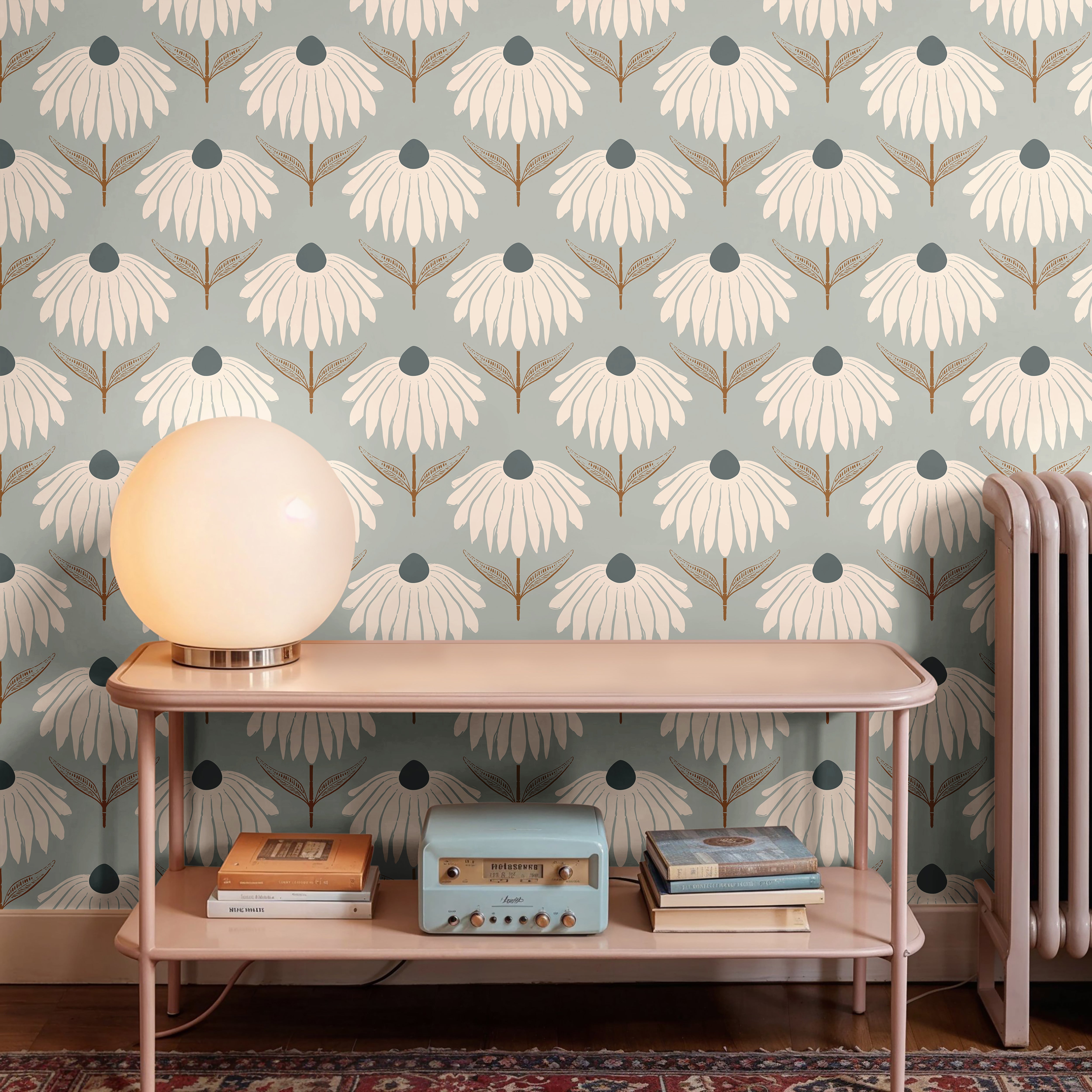 cream coneflower wallpaper behind blush console globe lamp vintage radio books and radiator