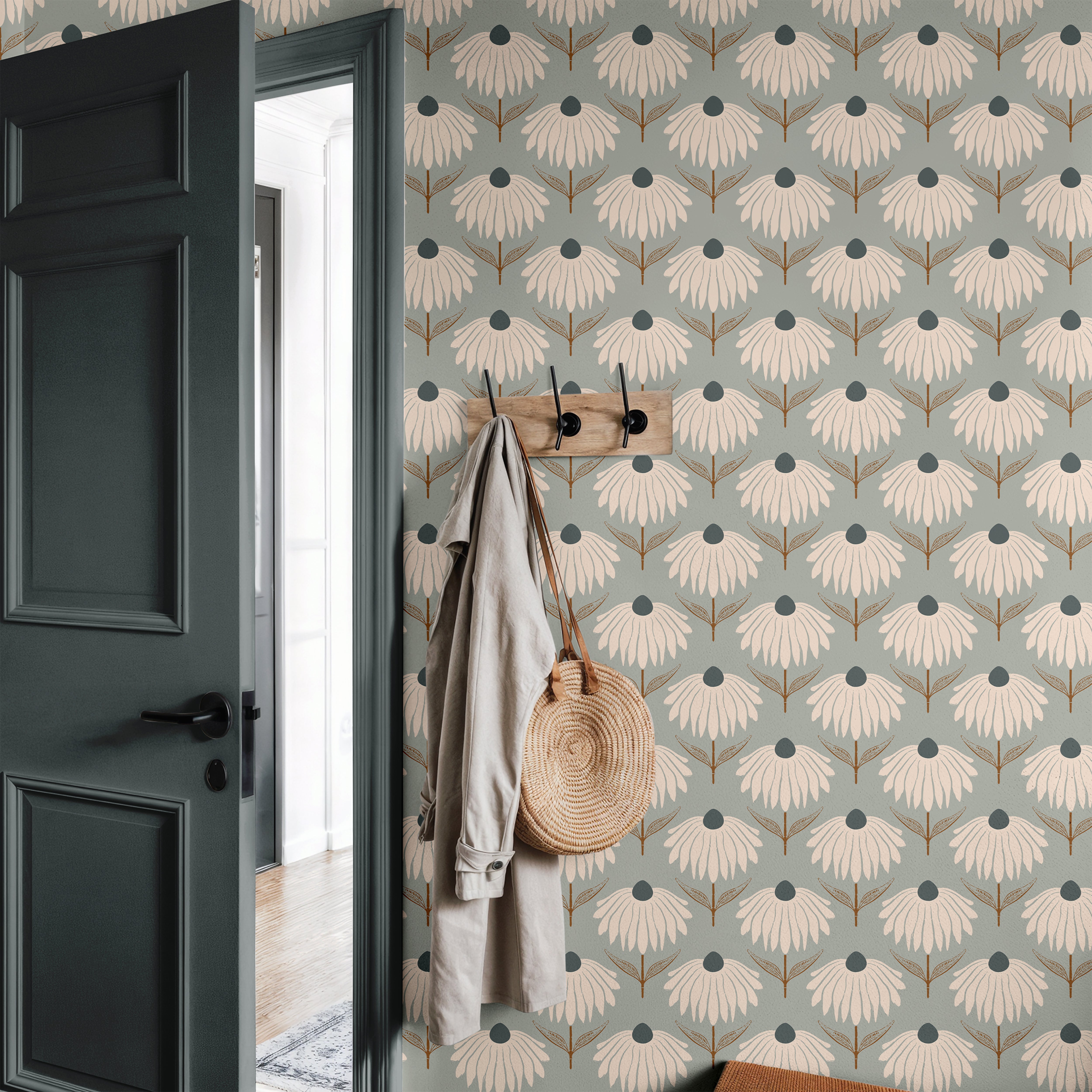  blue green floral wallpaper in entryway with dark door wood hooks neutral coat and woven bag
