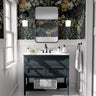 Moody floral wallpaper styled in a dramatic bathroom with navy vanity, black fixtures, and vintage botanical blooms.