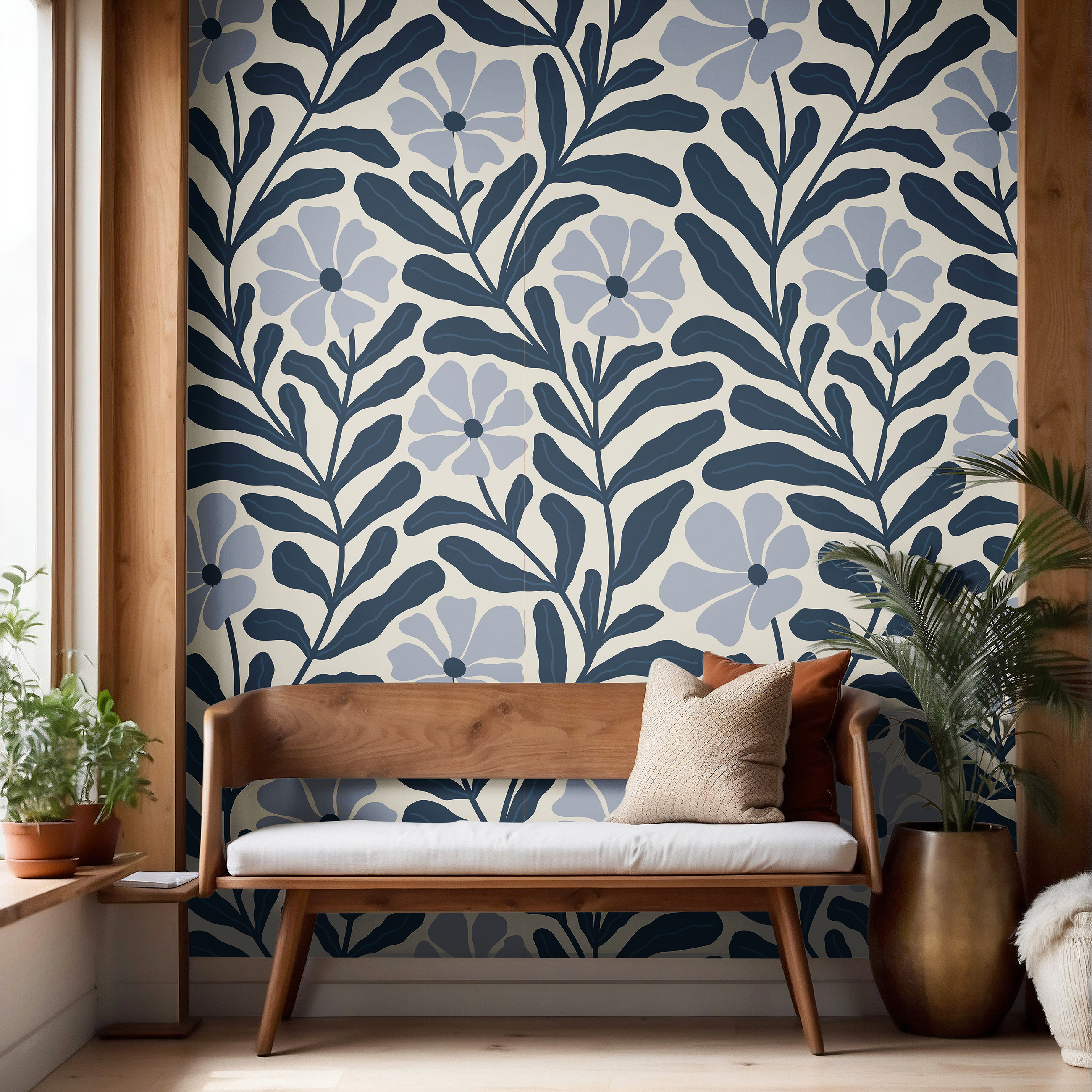 Navy and soft blue botanical wallpaper with oversized floral pattern styled above a wood bench with neutral decor.