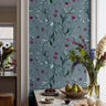 Moody botanical wallpaper featuring hand-drawn floral stems and soft organic detailing on a blue gray background.
