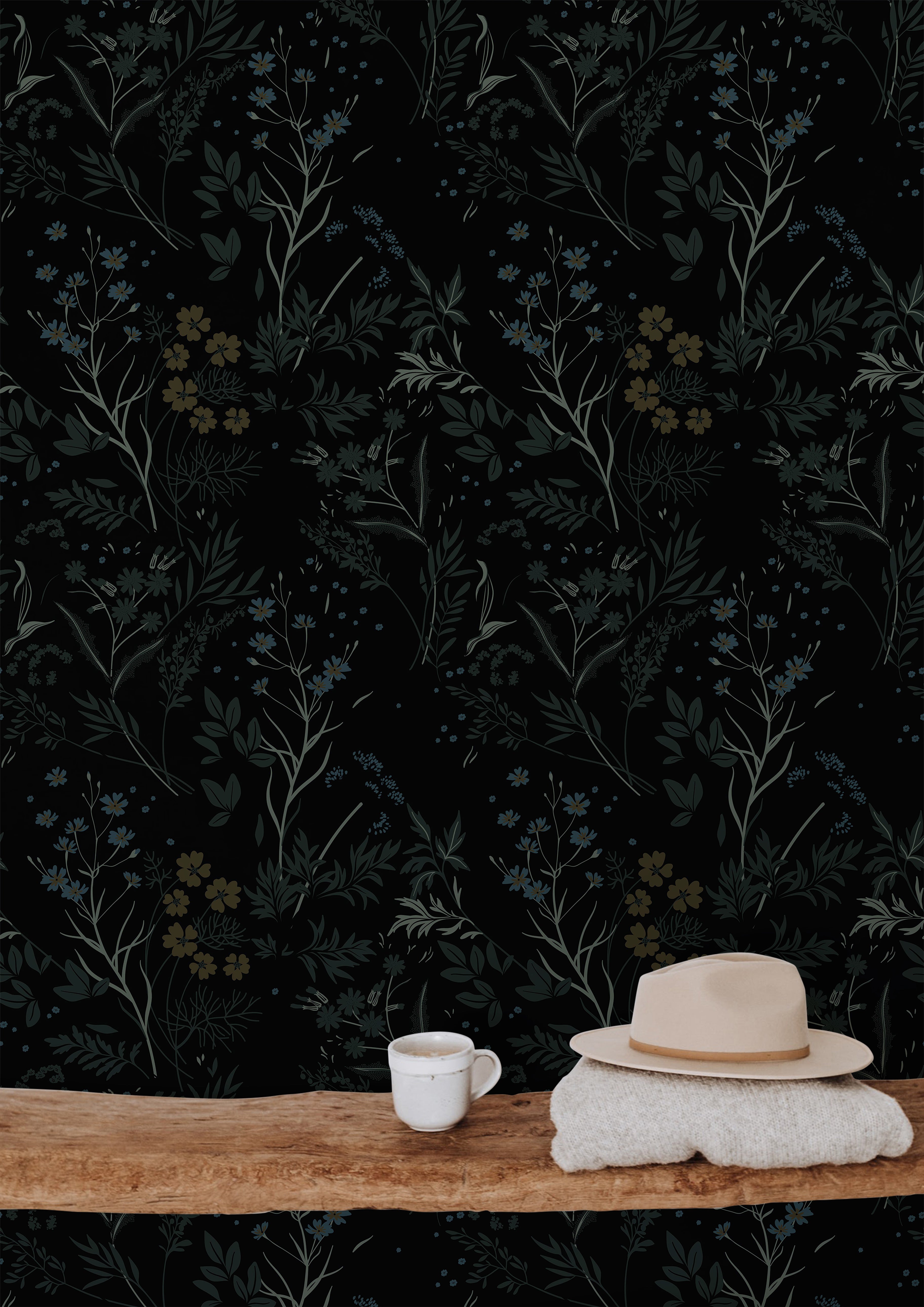 Moody botanical wallpaper featuring black floral wallpaper, muted blue wildflowers, earthy olive foliage, warm wood textures, and dark organic interior styling inspiration.