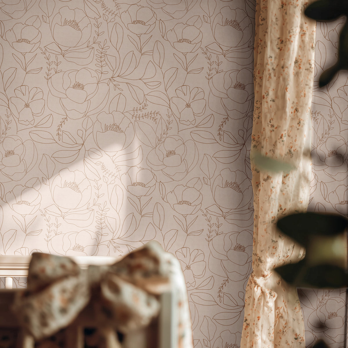 Open Bloom blush botanical wallpaper with delicate brown floral line art in a softly lit bedroom with vintage floral accents