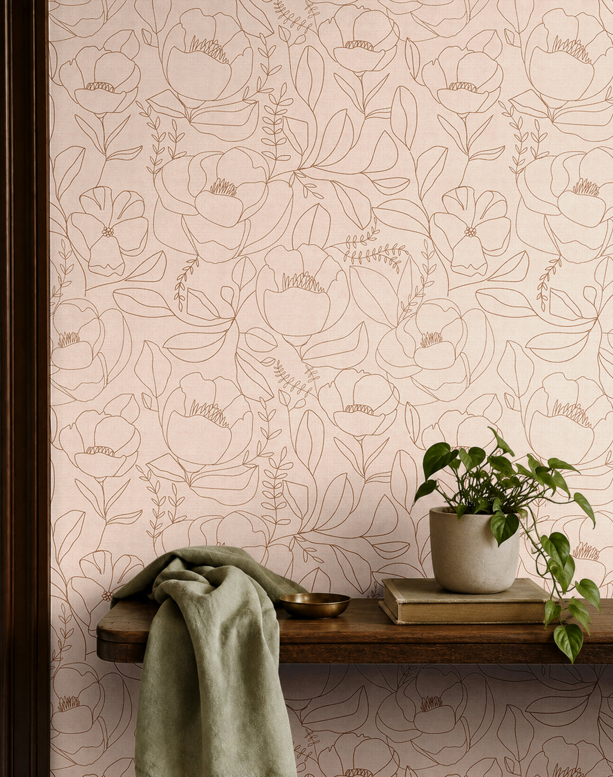 Open Bloom neutral blush floral wallpaper with oversized botanical line drawings styled above a vintage wood console