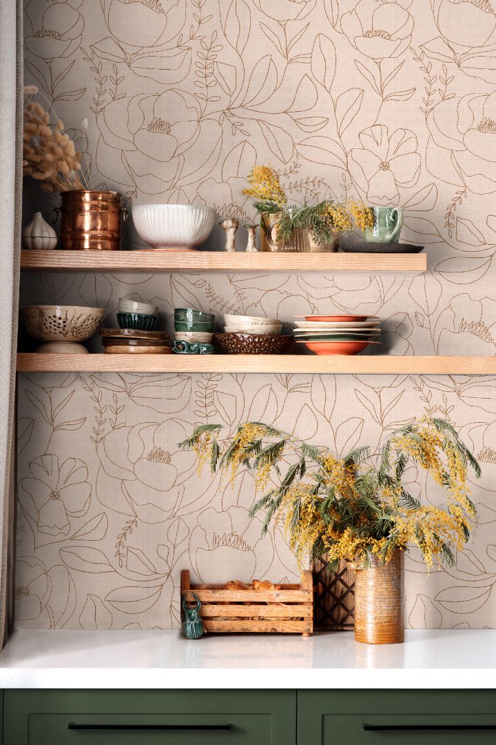 Line-drawn floral wallpaper in warm beige and clay tones styled in a kitchen shelving space