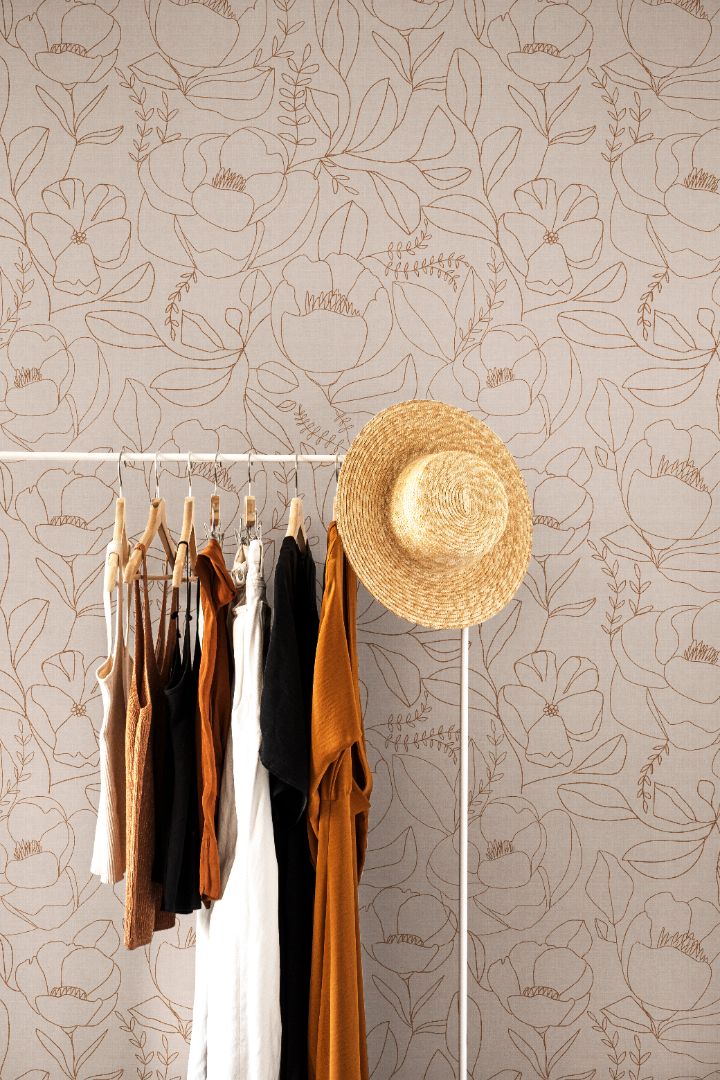 Neutral botanical wallpaper with clay linework on a beige background in a modern interior