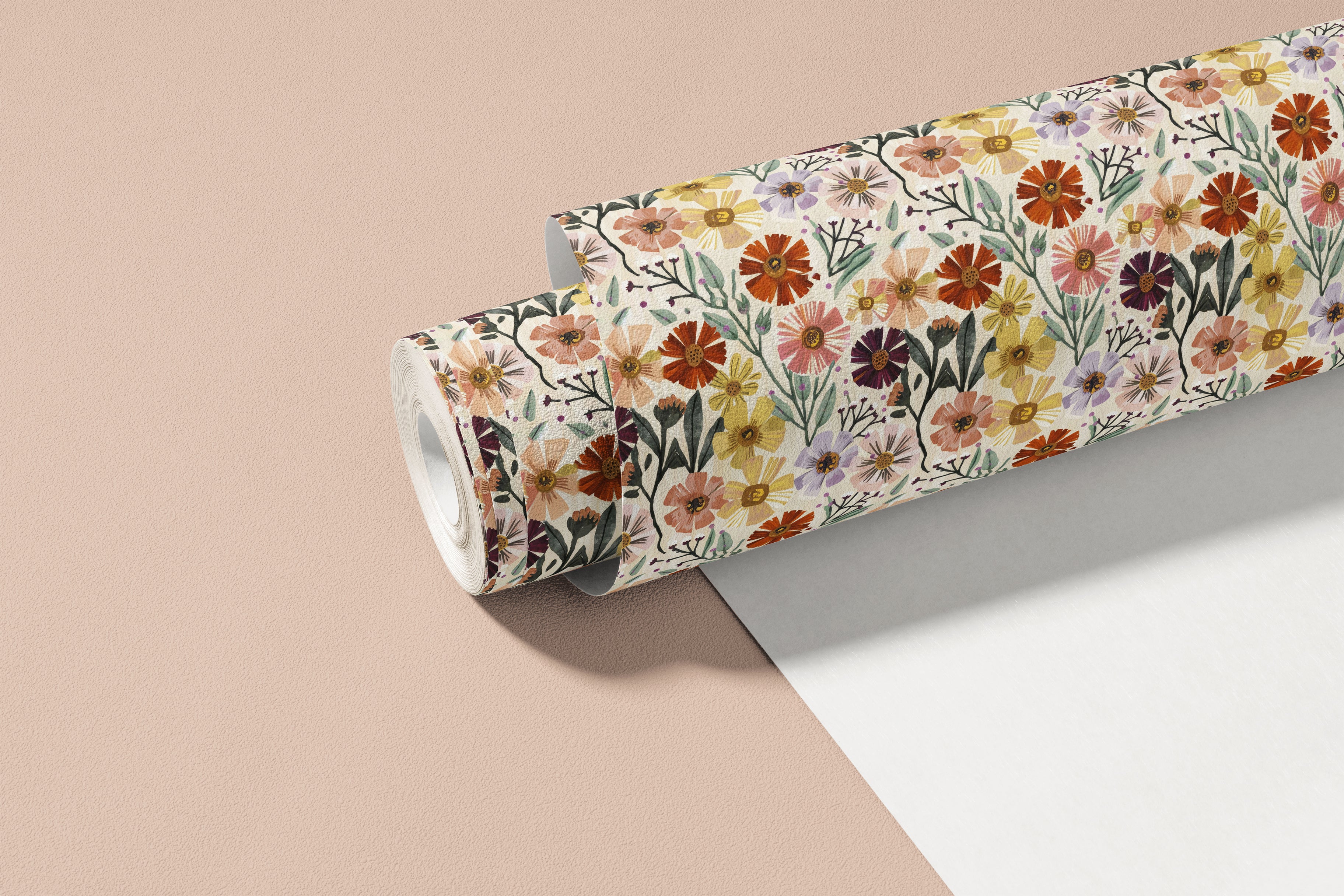  roll of painted bloomscape contact paper with multicolor flowers sage leaves and cream background on warm blush background