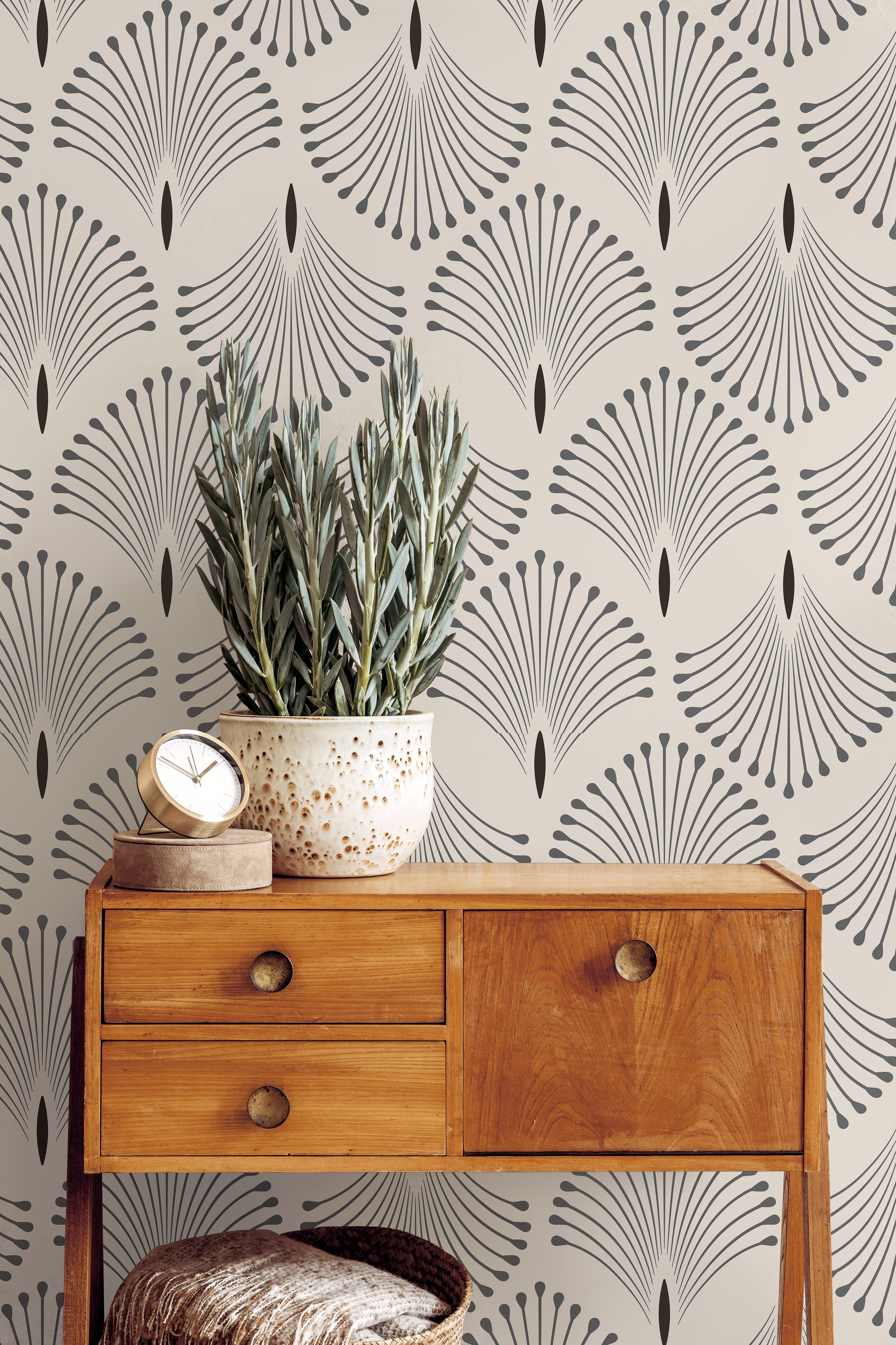 Neutral Art Deco wallpaper with repeating fan motifs styled beside warm wood furniture and soft organic decor