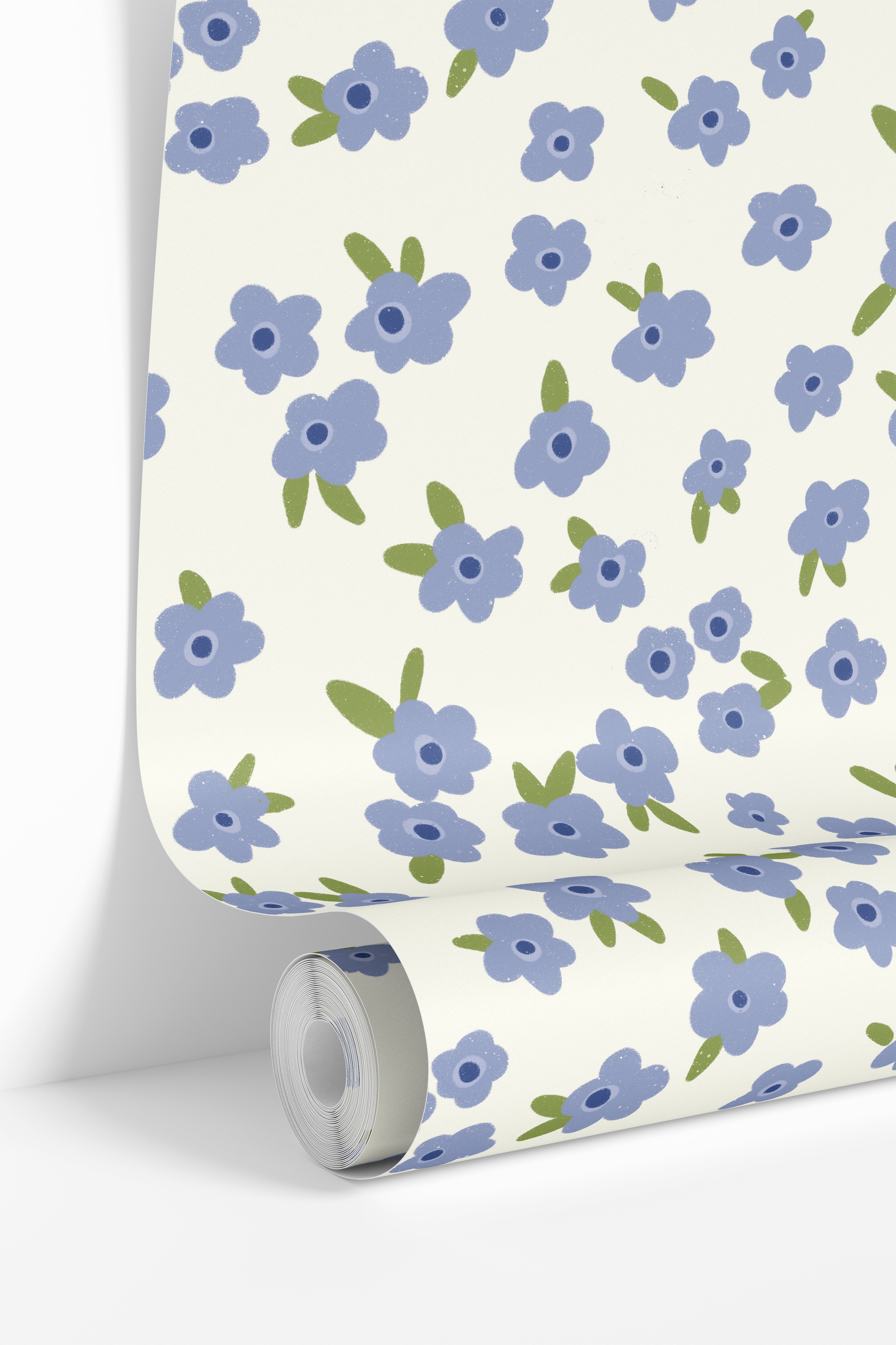 Wallpaper roll featuring the Petal Theory vintage floral wallpaper pattern with soft scattered blue blooms.