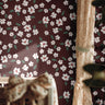 Close up of Petals in Merlot wallpaper showing ivory floral petals on a merlot background