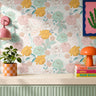 Pink, yellow and mint blooming roses on  white background with multi-colored leaves in a colorful living space