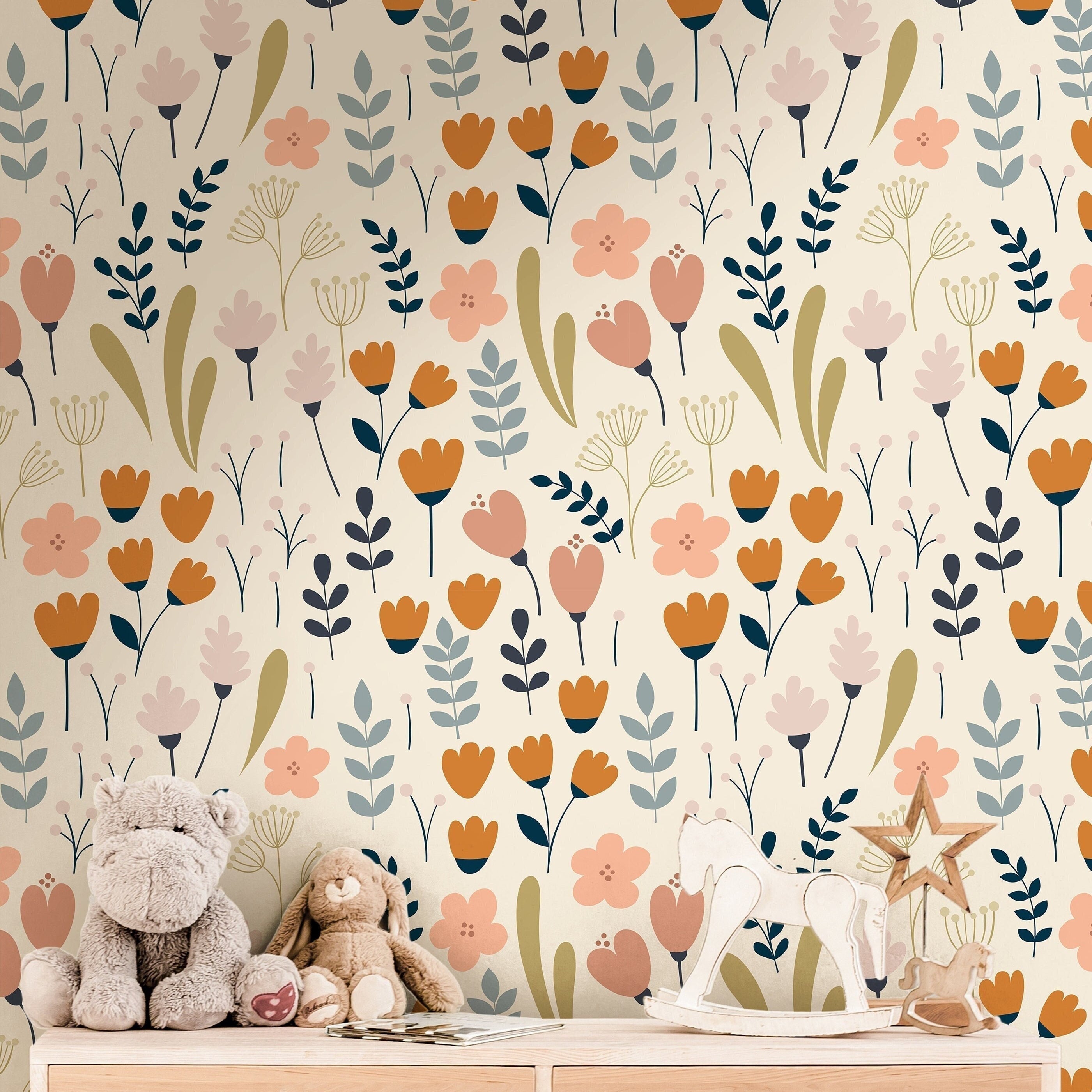 cream floral wallpaper in kids bedroom with pale wood bed mustard pillow blush decor and woven
storage