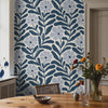 Navy Nature wallpaper featuring navy blue, soft blue, warm cream, natural wood, black accents, and modern botanical styling.
