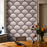 reservecroft burgundy art deco wallpaper behind wood dining table with cane chair and flowers