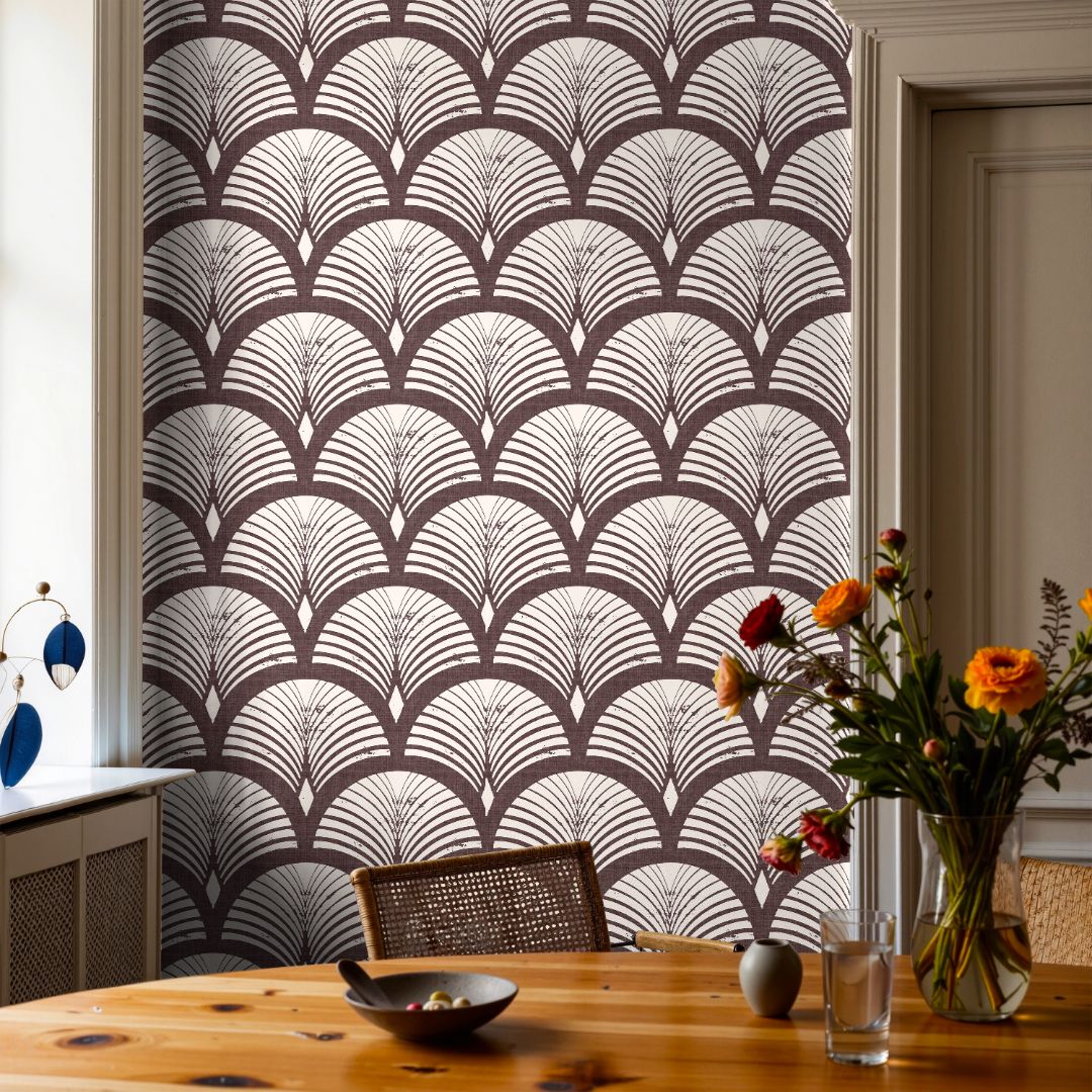 Burgundy wallpaper with warm ivory arch pattern in a styled interior with wood furniture