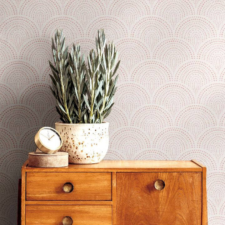 rosaline arch blush wallpaper behind mid century console table with potted plant and clock