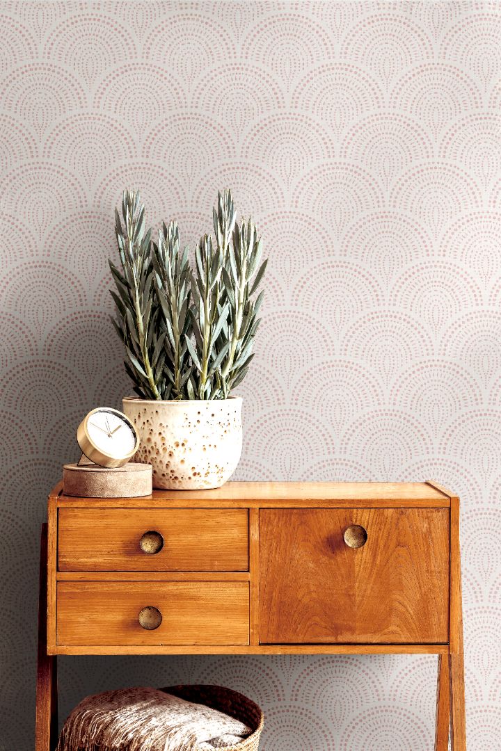 rosaline arch blush wallpaper behind mid century console table with potted plant and clock