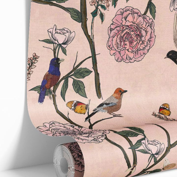 Rosy Aviary wallpaper roll showing blush background with birds, butterflies, and florals by James & Colors