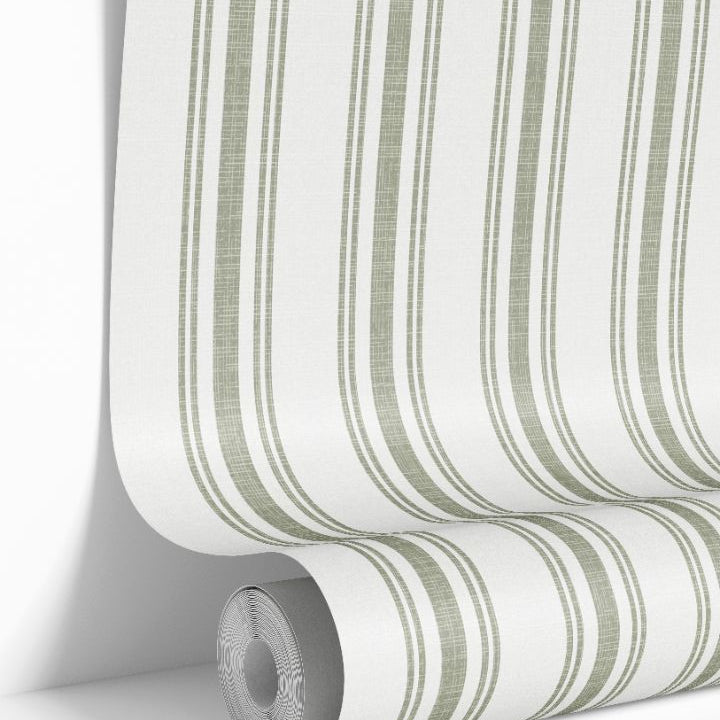 Sage Lineage wallpaper roll featuring vertical sage green stripes on warm white background by James & Colors