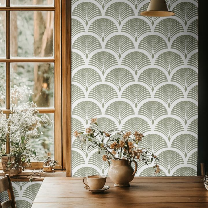  sagecroft olive green art deco wallpaper behind wood dining table with dried flowers and pendant light