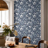 Blue floral wallpaper with layered hand drawn flowers styled in a bright dining room.