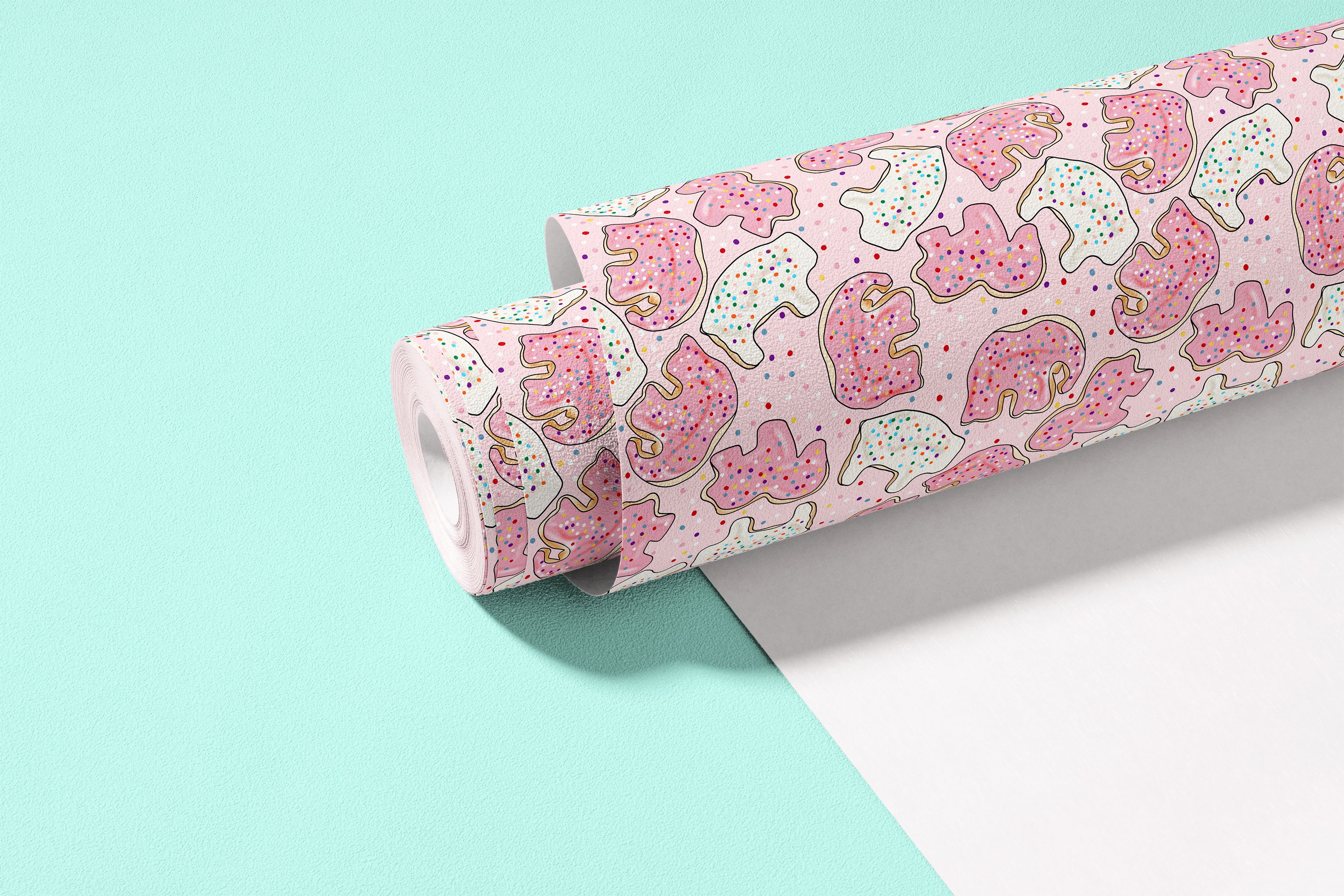 roll of sprinkle safari pink contact paper with frosted animal cookies and colorful sprinkles on bright blue background
