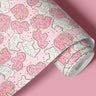 roll of sprinkle safari pink contact paper with frosted animal cookies and colorful sprinkles on bright pink background

