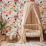 Nursery with canopy crib against large-scale blush and coral wildflower wallpaper, sage leaves and cream background, pattern 987
