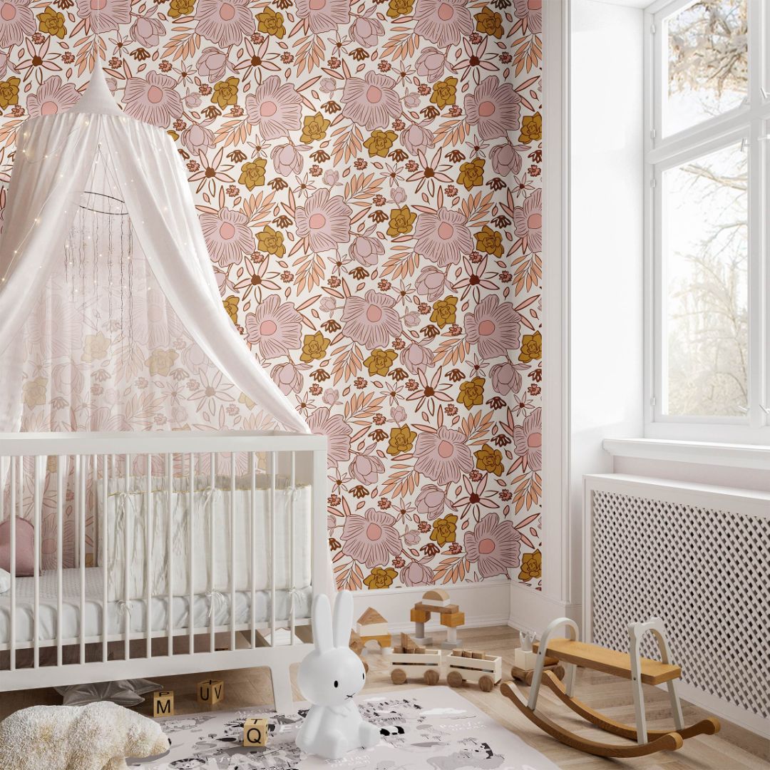 weetbriar Nursery floral wallpaper installed in a nursery with blush pink and mustard flowers on a light background-