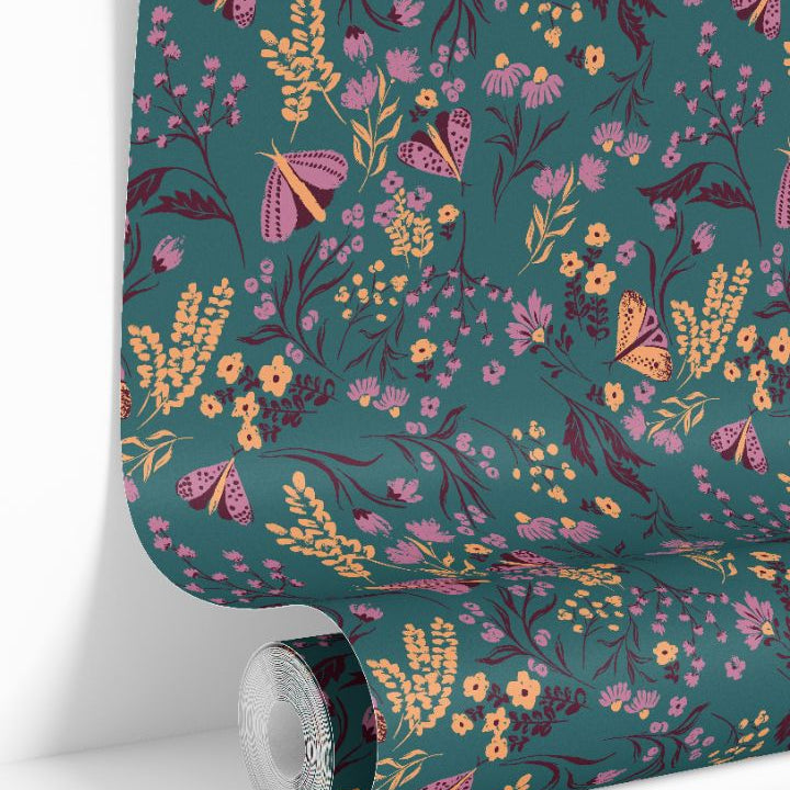 Wallpaper roll displaying Tealmore Wilds teal botanical wallpaper pattern with butterflies and wildflowers.