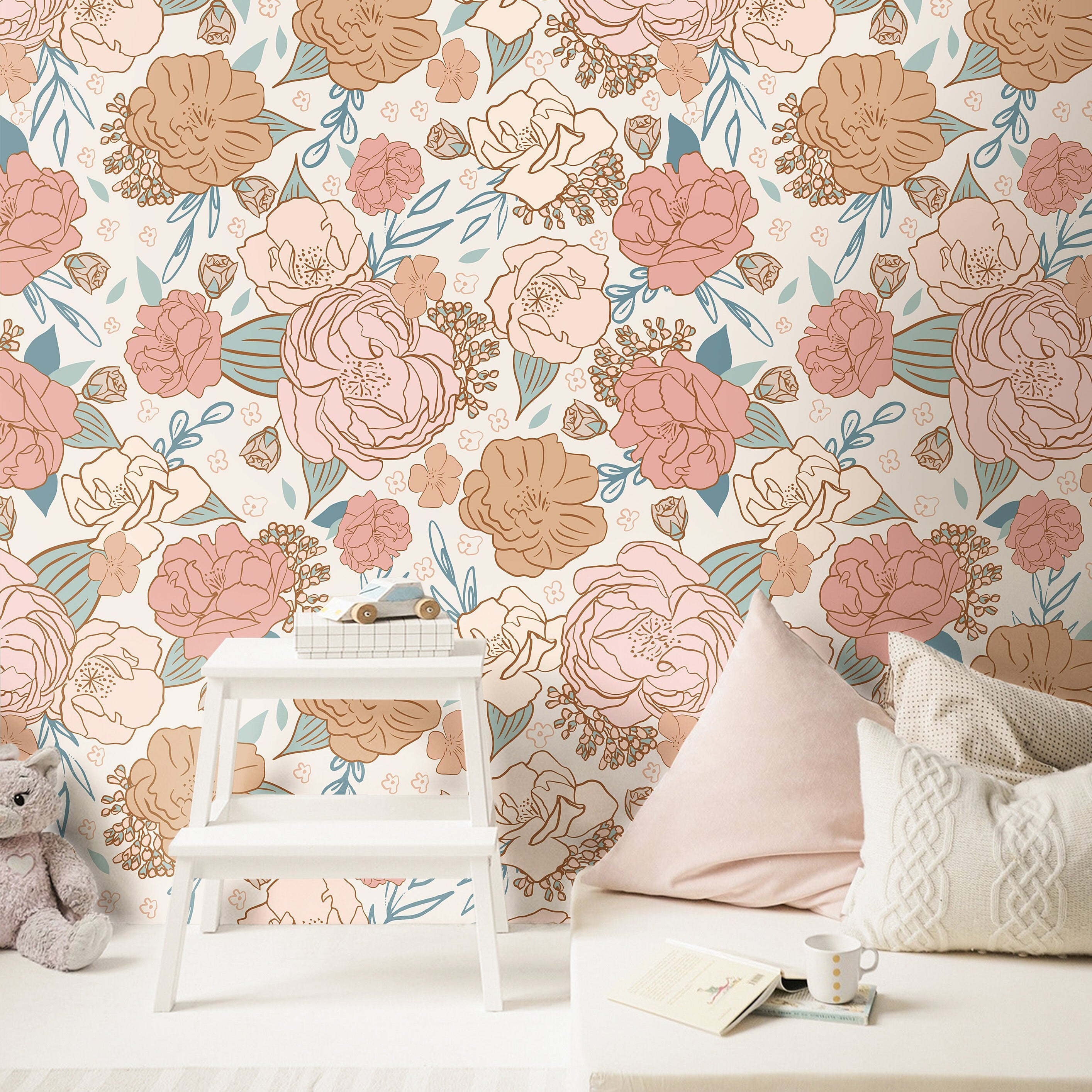 blush and peach floral wallpaper in reading nook with white bench books cushions and woven storage