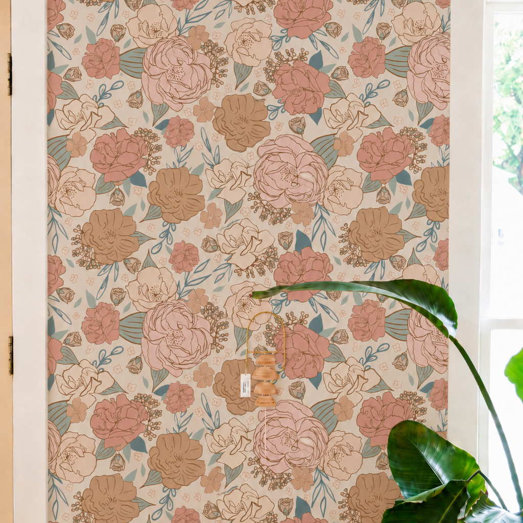 blush and peach floral wallpaper in living corner, with small marble table with stacks of books and wall decor