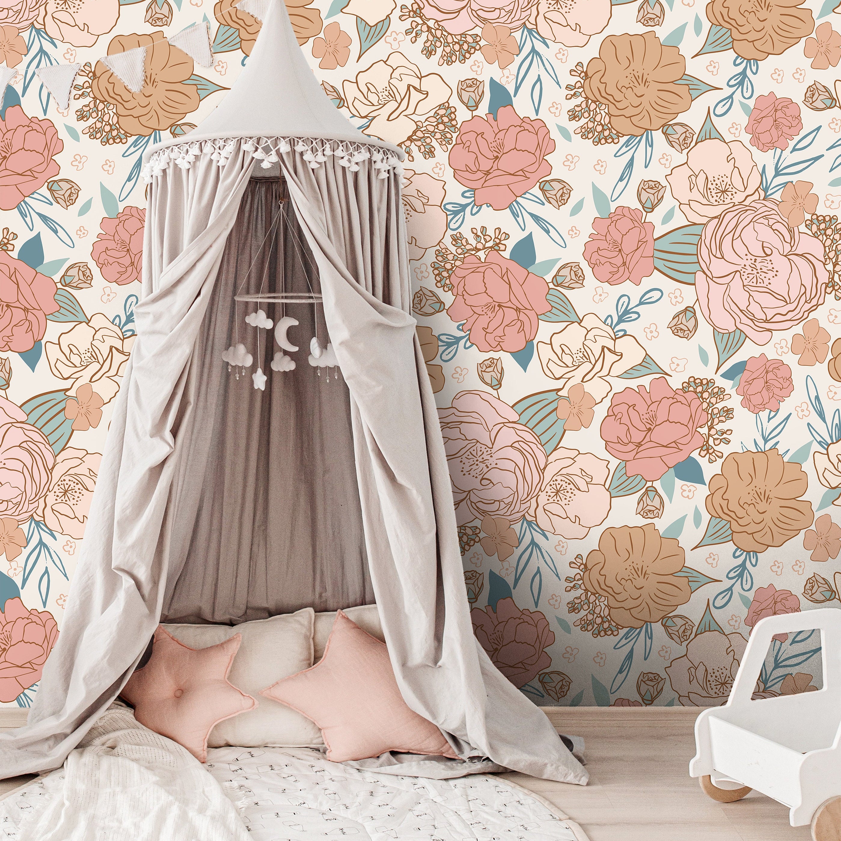 blush floral wallpaper behind white crib with peach canopy woven baskets and soft nursery decor