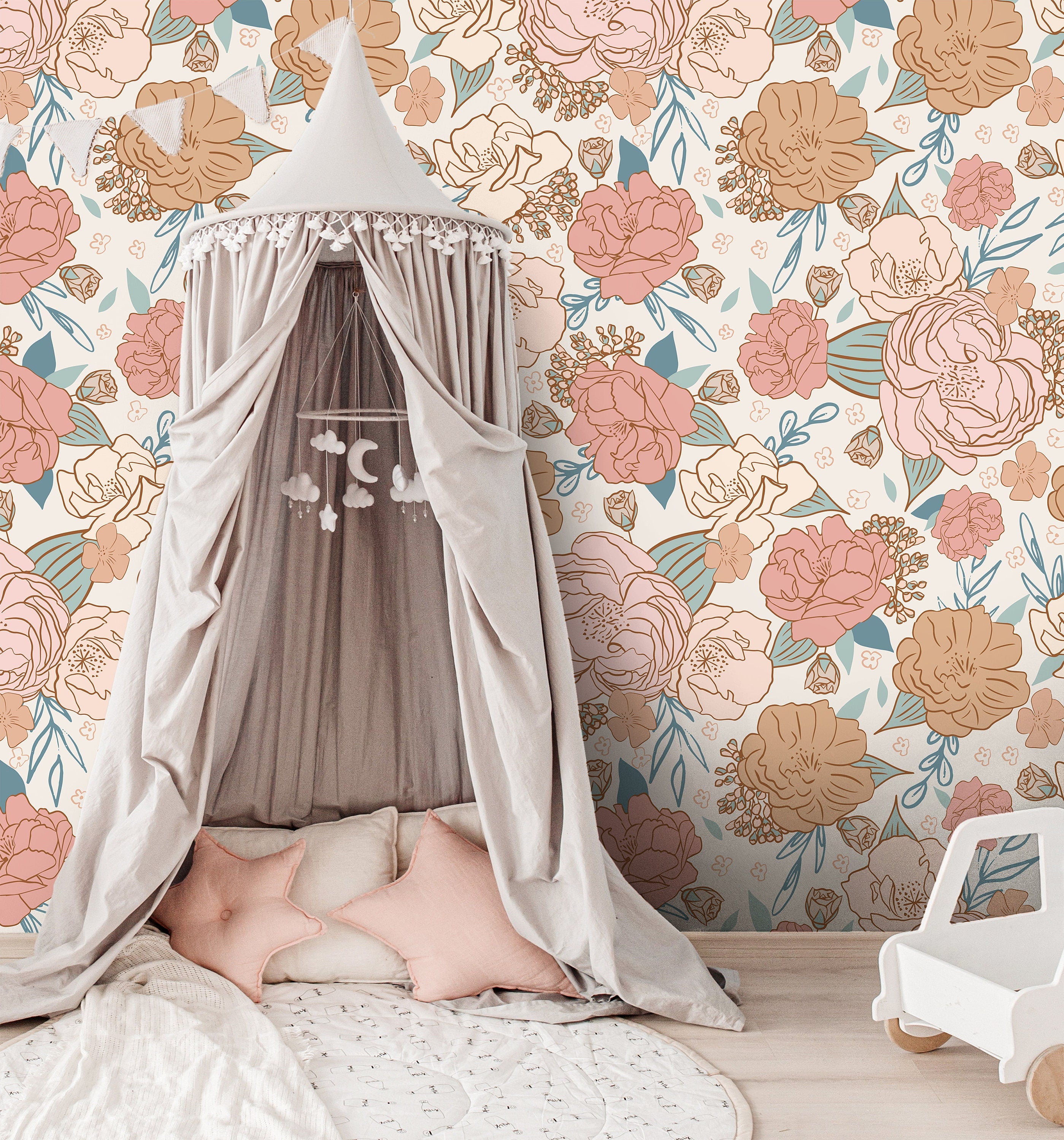 blush floral wallpaper behind white crib with peach canopy woven baskets and soft nursery decor
