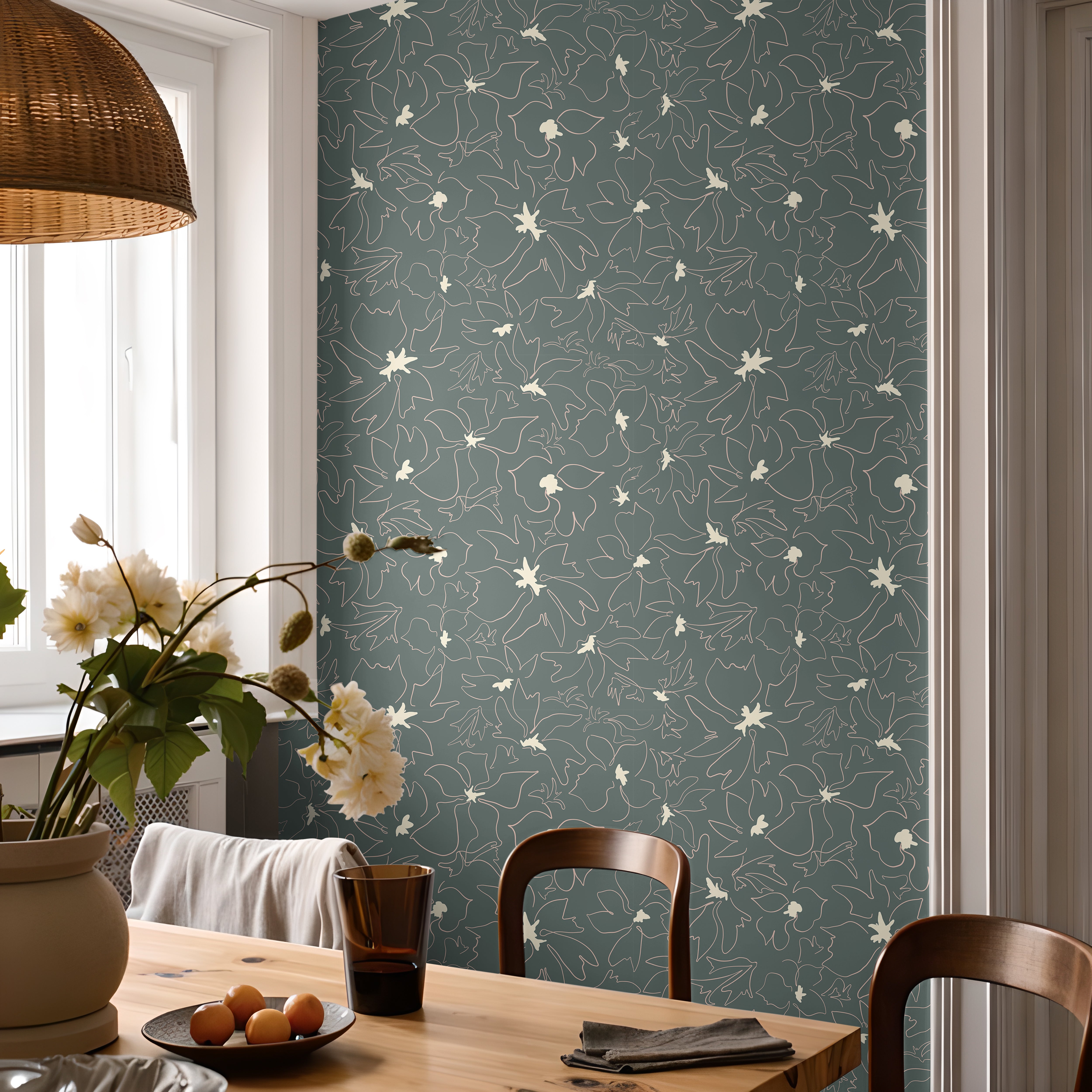 blue green floral outline wallpaper in dining room with wooden table
