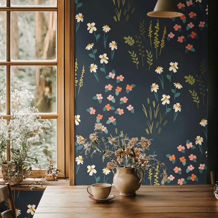 Dining area with Vivenne Grove Wallpaper showcasing coral, gold, and sage florals on navy walls for an elegant and vibrant look.