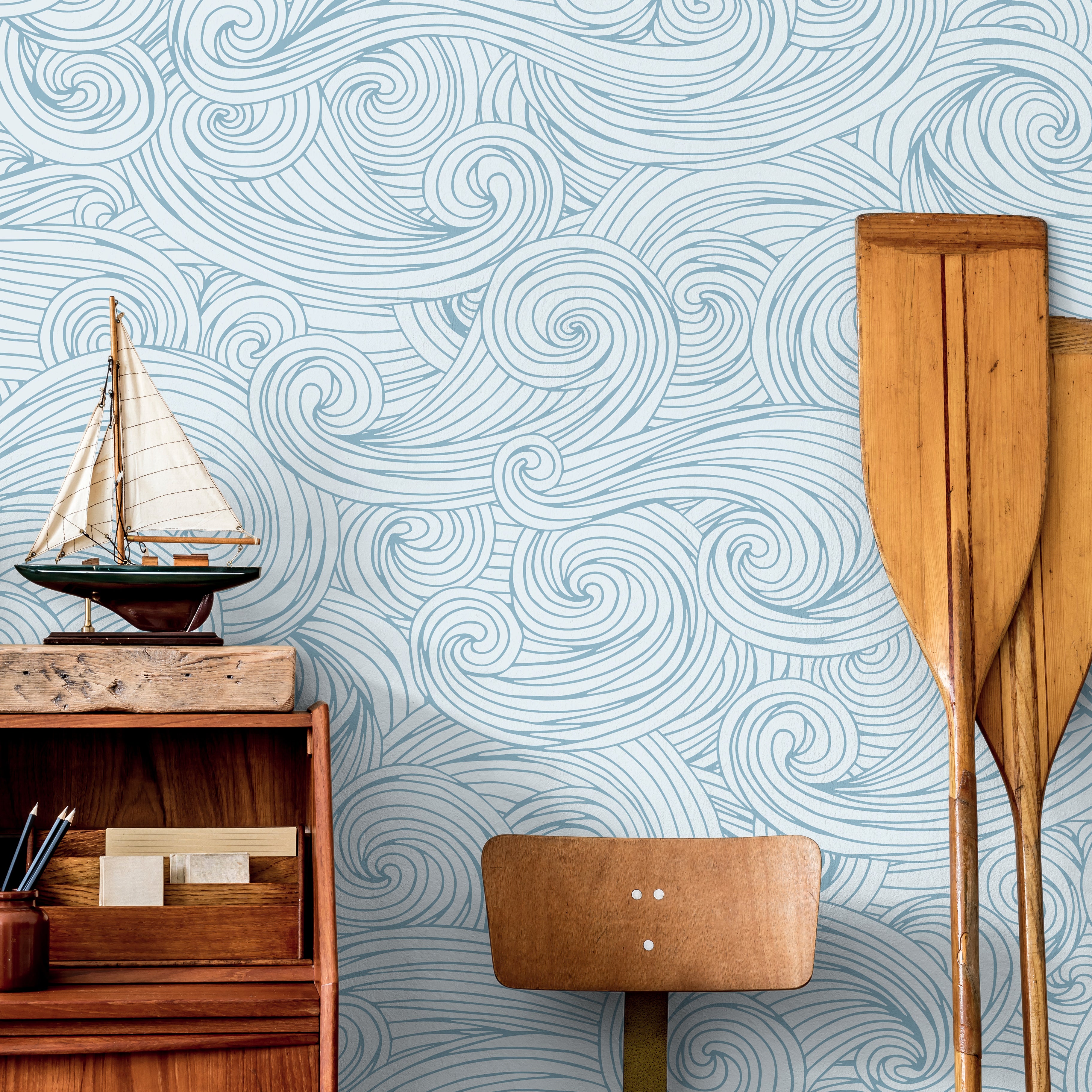 Ocean inspired wallpaper with flowing hand-drawn wave detailing styled in a calm coastal interior