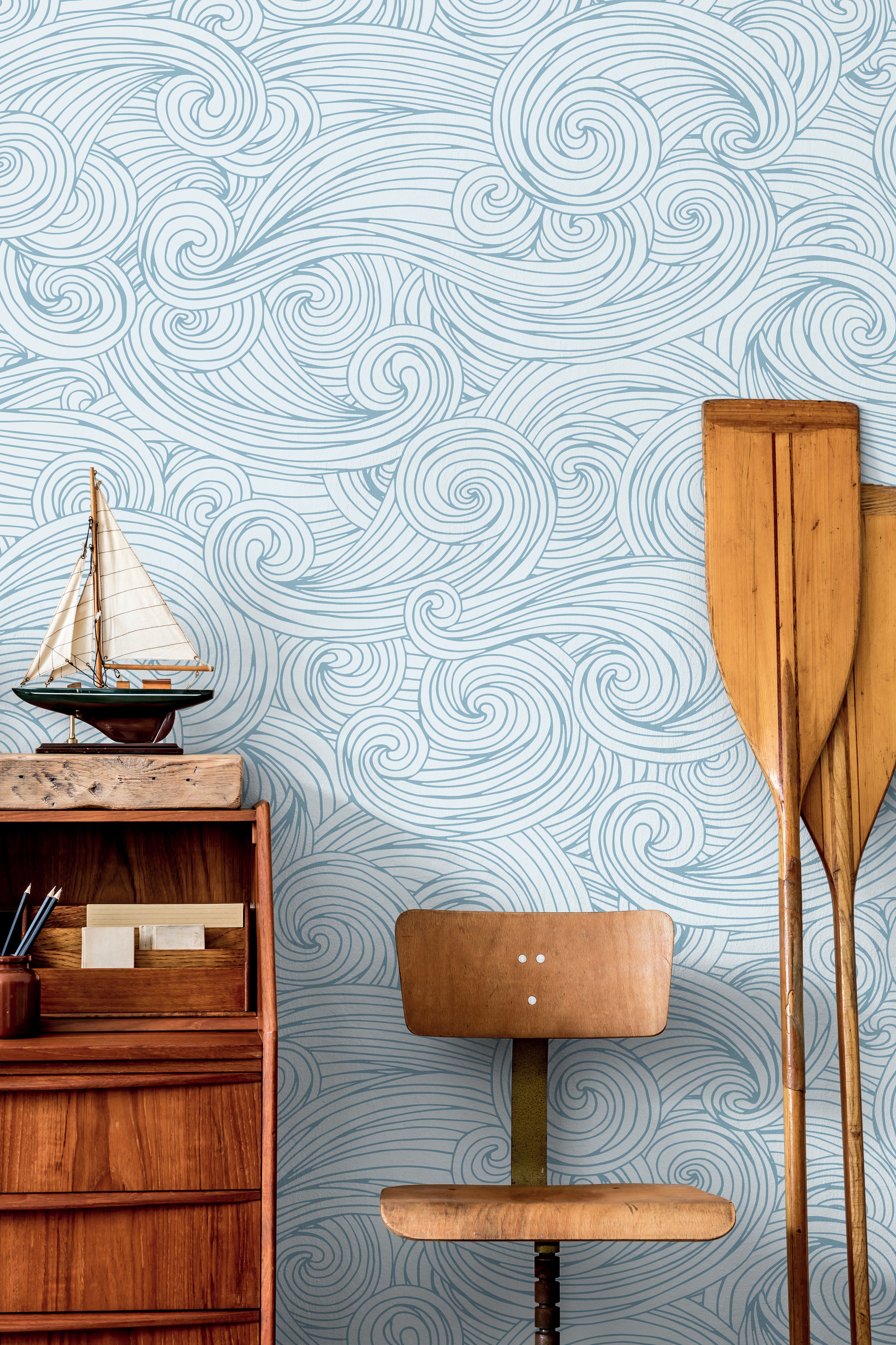 Ocean inspired wallpaper with flowing hand-drawn wave detailing styled in a calm coastal interior