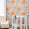 Warm Bloom colorful floral wallpaper with coral flowers, soft blue blossoms and peach foliage in a bright neutral nursery